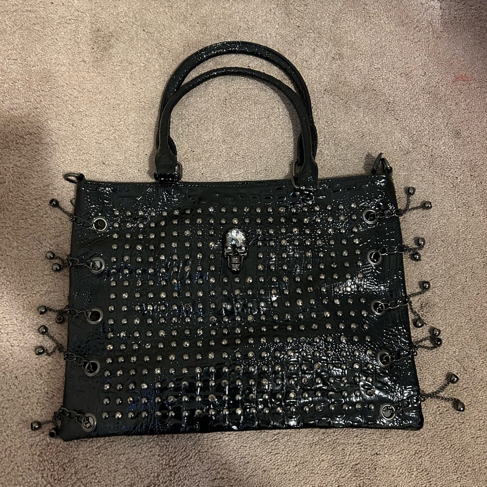 Black patten faux leather, beaded detail with skull emblem bag.